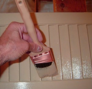 Paintbrush painting a radiator